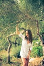 Attractive, young brunette on the beach, amid olive trees Royalty Free Stock Photo