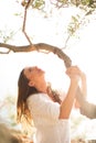 Attractive, young brunette on the beach, amid olive trees Royalty Free Stock Photo