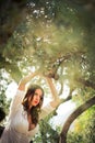 Attractive, young brunette on the beach, amid olive trees Royalty Free Stock Photo