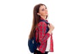 Attractive young brunette student girl with blue backpack isolated on white background Royalty Free Stock Photo