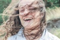 Attractive young brunette woman with curly magnificent hair laughing on the nature. Royalty Free Stock Photo