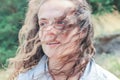 Attractive young brunette woman with curly magnificent hair laughing on the nature. Royalty Free Stock Photo