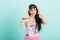 Attractive young brunette woman in pink tank top on blue background. smilling girl in sunglasses Royalty Free Stock Photo