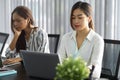 Attractive young business female employee sits in the modern office