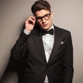 Attractive young business man fixing his glasses Royalty Free Stock Photo