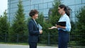 Attractive young business women talking meeting outdoors shaking hands