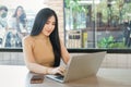 Attractive young business woman using laptop computer at coffee shop in the urban Royalty Free Stock Photo