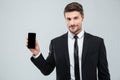 Attractive young businessman showing blank screen cell phone Royalty Free Stock Photo