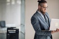 Attractive young businessman in stylish suit using laptop Royalty Free Stock Photo