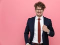 Attractive young businessman wearing glasses and fixing suit Royalty Free Stock Photo