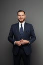 Attractive young businessman wearing suit on grey background Royalty Free Stock Photo