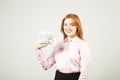 Attractive young businesswoman posing with bunch of USD cash in hands showing positive emotions and happy facial expression. Royalty Free Stock Photo