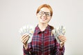 Attractive young businesswoman posing with bunch of USD cash in hands showing positive emotions and happy facial expression. Royalty Free Stock Photo