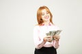 Attractive young businesswoman posing with bunch of USD cash in hands showing positive emotions and happy facial expression. Royalty Free Stock Photo