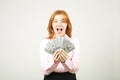 Attractive young businesswoman posing with bunch of USD cash in hands showing positive emotions and happy facial expression. Royalty Free Stock Photo