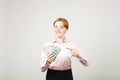 Attractive young businesswoman posing with bunch of USD cash in hands showing positive emotions and happy facial expression. Royalty Free Stock Photo