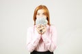 Attractive young businesswoman posing with bunch of USD cash in hands showing positive emotions and happy facial expression. Royalty Free Stock Photo