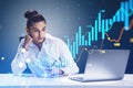 Attractive young businesswoman sitting and using laptop glowing candlestick forex chart on blurry blue background. Trade, finance