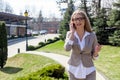 Attractive young businesswoman talking on the phone and smiling.Woman wearing suit and glasses. Royalty Free Stock Photo