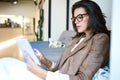 Attractive young businesswoman using her digital tablet in the coffee shop. Royalty Free Stock Photo