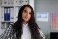 Attractive young businesswoman wearing stylish jacket posing in company office Royalty Free Stock Photo