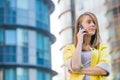 Attractive young businness woman with smart phone in the city Royalty Free Stock Photo