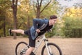 Young handsome caucasian man bicycling at the park