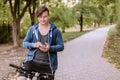 Handsome caucasia man with round eyeglass and earphones bicycling in the park