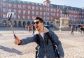 Handsome young student tourist man happy and excited taking a selfie in Madrid, Spain Royalty Free Stock Photo