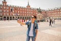 Handsome young caucasian tourist man happy and excited taking a selfie in Plaza Mayor, Madrid Spain Royalty Free Stock Photo