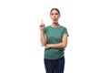 attractive young caucasian woman with black hair in a t-shirt has an idea and holds her index finger up Royalty Free Stock Photo