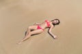 Attractive Young Caucasian Woman In Swimsuit Lying On Beach Top View, Girl Wet Sand Sea Ocean Holiday Royalty Free Stock Photo