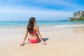 Attractive Young Caucasian Woman In Swimsuit Sitting On Beach Back Rear View, Girl Blue Sea Water Holiday Royalty Free Stock Photo