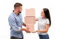 Attractive young couple carrying moving boxes on white background Royalty Free Stock Photo
