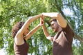 Attractive young couple dancing sensual bachata with arms up in an outdoor park surrounded by greenery. Latin dance concept, Royalty Free Stock Photo