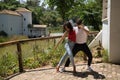 Attractive young couple dancing sensual bachata in an outdoor park with a river in the background. Latin, sensual, folkloric, Royalty Free Stock Photo