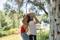 Attractive young couple dancing sensual bachata in an outdoor park, surrounded by trees, next to a river. Latin, sensual, Royalty Free Stock Photo