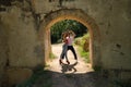 Attractive young couple dancing sensual bachata under an ancient stone arch in an outdoor park. Latin, sensual, folkloric, urban