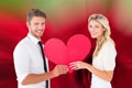 Attractive young couple holding red heart Royalty Free Stock Photo