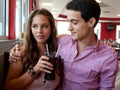 Attractive Young Couple Sharing Soda at Restaurant Royalty Free Stock Photo