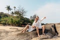 Attractive young couple sitting on the beach Royalty Free Stock Photo