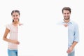 Attractive young couple smiling at camera holding poster Royalty Free Stock Photo