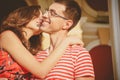 Attractive young couple smiling and kissing. Close up of happy couple in red clothes