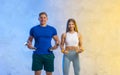 Attractive young couple in sport wear doing exercise in the gym. Strength and motivation concept. Workout online theme Royalty Free Stock Photo