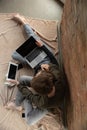 Attractive young couple using devices together, tablet, laptop, smartphone, headphones wireless. Gadgets and Royalty Free Stock Photo