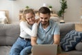 Attractive young couple using laptop sitting on couch at home Royalty Free Stock Photo