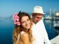 Attractive young couple walking alongside the marina - wedding c