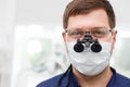 Attractive young dental doctor is working in his Royalty Free Stock Photo