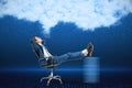 Attractive young european businessman laying on chair on blurry digital blue background with abstract cloud. Cloud computing, big Royalty Free Stock Photo