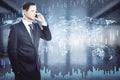 Attractive young european businessman talking on the phone with abstract big data map hologram in blurry office interior. Royalty Free Stock Photo
